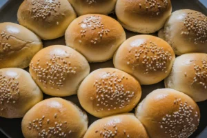 Egg white burger buns fresh out of the oven, golden and lightly textured.