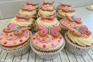 An artistic close-up of a butterfly cake, with focus on jam, cream, and cake textures.